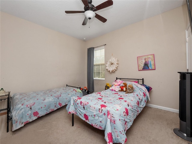 bedroom with carpet floors, a ceiling fan, and baseboards