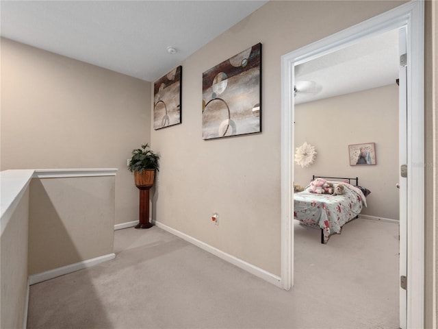 hall with carpet flooring and baseboards