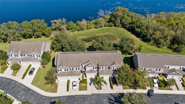 aerial view of residential area featuring a nearby body of water