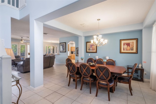 8571 La Isla Dr, Kissimmee, FL 34747 - dining space with a chandelier, light tile patterned flooring, arched walkways, and a ceiling fan