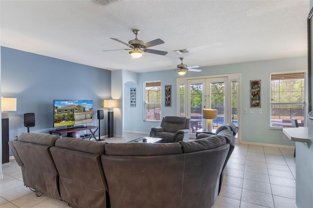8571 La Isla Dr, Kissimmee, FL 34747 - living room featuring light tile patterned floors, a ceiling fan, and a textured ceiling