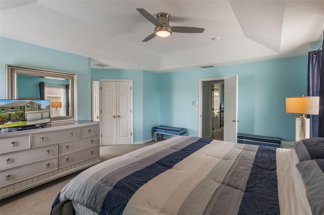 8571 La Isla Dr, Kissimmee, FL 34747 - bedroom with a tray ceiling, carpet, and ceiling fan