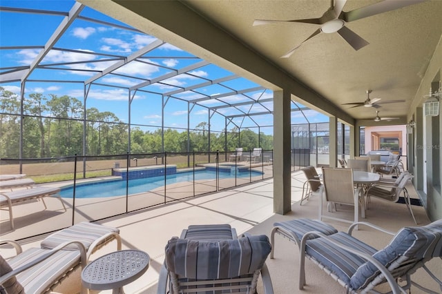 8571 La Isla Dr, Kissimmee, FL 34747 - view of patio / terrace featuring a ceiling fan, a pool with connected hot tub, a lanai, and view of scattered trees
