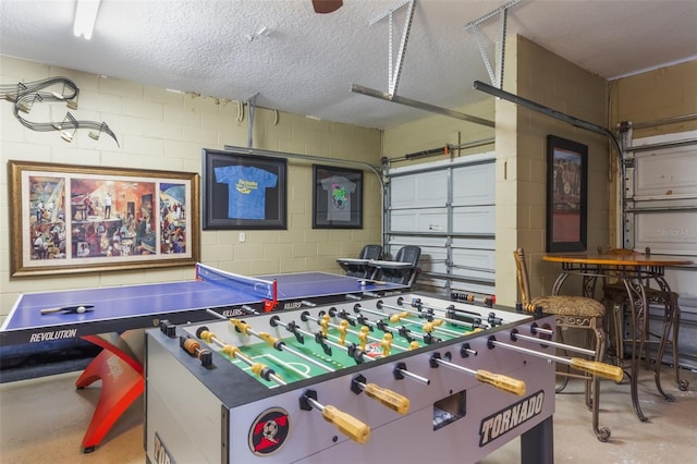 8571 La Isla Dr, Kissimmee, FL 34747 - rec room featuring concrete block wall, concrete floors, a garage, and a textured ceiling