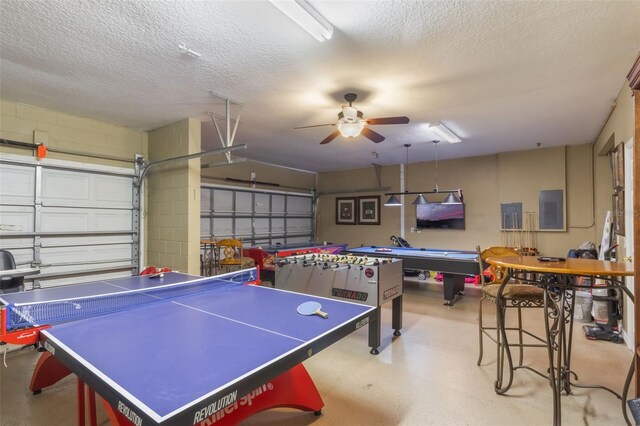 8571 La Isla Dr, Kissimmee, FL 34747 - recreation room with electric panel, a garage, ceiling fan, a textured ceiling, and finished concrete flooring