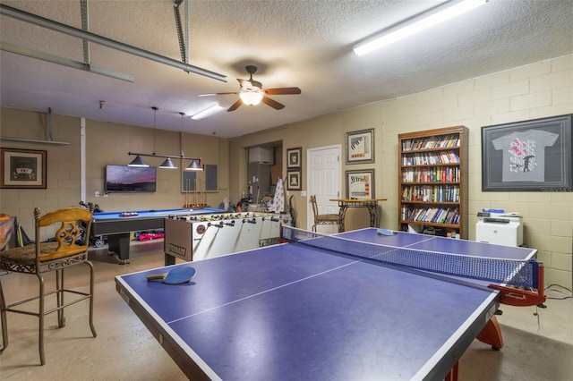 8571 La Isla Dr, Kissimmee, FL 34747 - game room with finished concrete floors, a textured ceiling, a ceiling fan, concrete block wall, and billiards table
