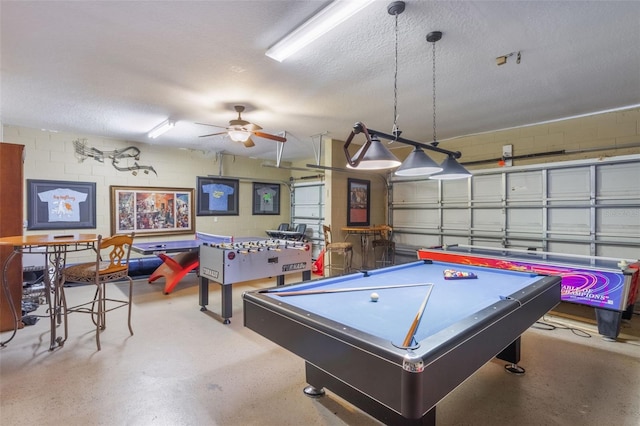 8571 La Isla Dr, Kissimmee, FL 34747 - recreation room featuring concrete block wall, a ceiling fan, billiards table, and a textured ceiling