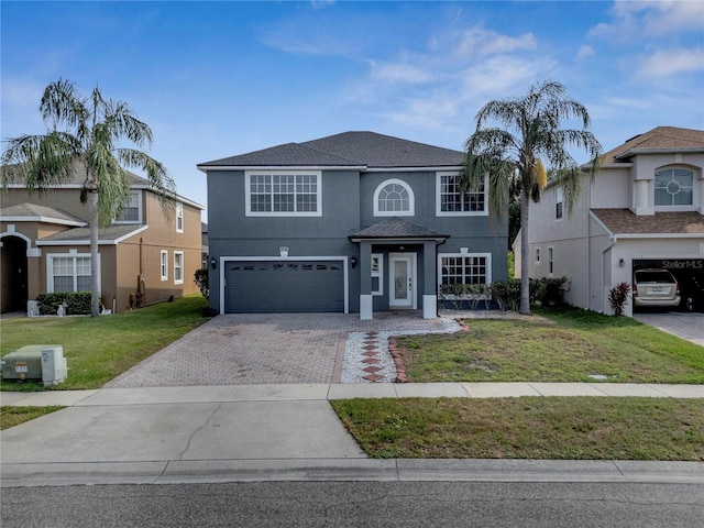 5768 Los Palma Vista Dr, Orlando, FL 32837 - traditional-style house with an attached garage, decorative driveway, stucco siding, and a front lawn