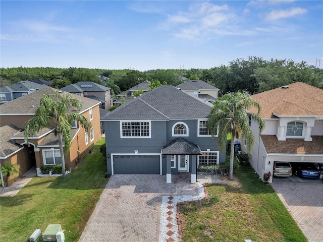 5768 Los Palma Vista Dr, Orlando, FL 32837 - traditional-style house with driveway, stucco siding, an attached garage, a residential view, and a front yard