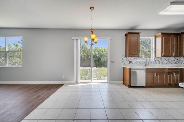 5768 Los Palma Vista Dr, Orlando, FL 32837 - kitchen with dishwasher, a chandelier, healthy amount of natural light, and light countertops