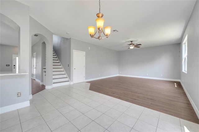 5768 Los Palma Vista Dr, Orlando, FL 32837 - spare room with a ceiling fan, a chandelier, light wood-type flooring, and stairway