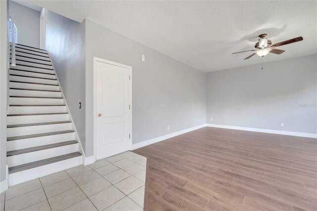 5768 Los Palma Vista Dr, Orlando, FL 32837 - spare room featuring a ceiling fan, light wood finished floors, stairway, and baseboards