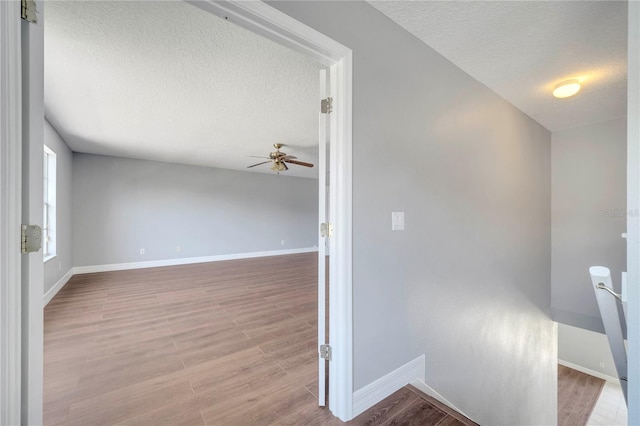 5768 Los Palma Vista Dr, Orlando, FL 32837 - hall featuring a textured ceiling, baseboards, and wood finished floors
