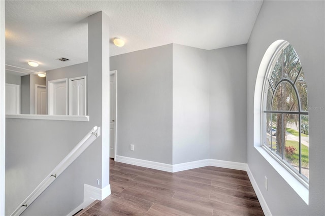 5768 Los Palma Vista Dr, Orlando, FL 32837 - unfurnished room with wood finished floors, baseboards, and a textured ceiling