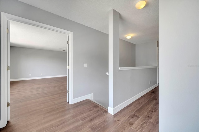 5768 Los Palma Vista Dr, Orlando, FL 32837 - corridor with baseboards, wood finished floors, and a textured ceiling