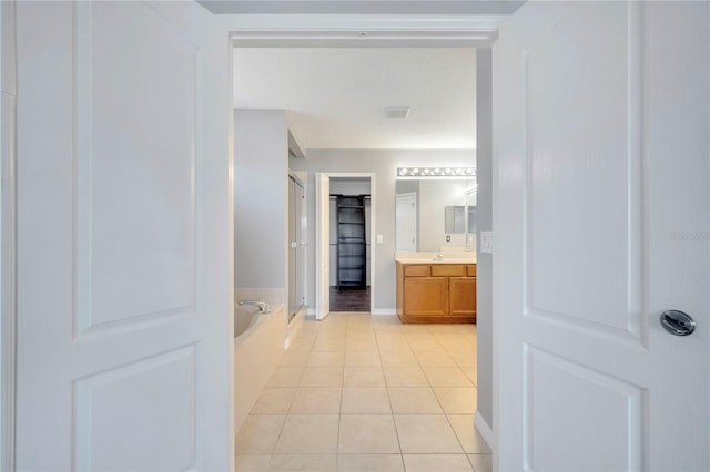 5768 Los Palma Vista Dr, Orlando, FL 32837 - full bathroom featuring tile patterned floors, vanity, a bath, a stall shower, and baseboards