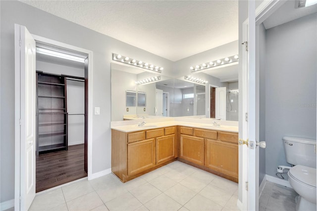 5768 Los Palma Vista Dr, Orlando, FL 32837 - bathroom with toilet, baseboards, tile patterned floors, and double vanity
