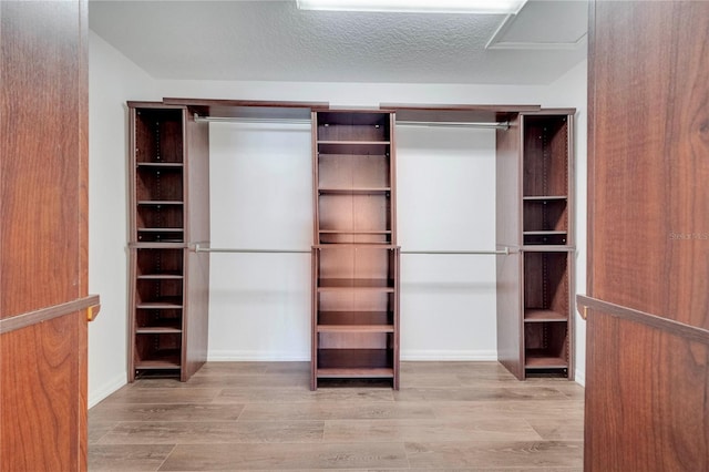 5768 Los Palma Vista Dr, Orlando, FL 32837 - walk in closet featuring wood finished floors