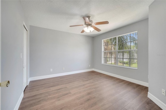 5768 Los Palma Vista Dr, Orlando, FL 32837 - spare room featuring wood finished floors, a textured ceiling, a ceiling fan, and baseboards