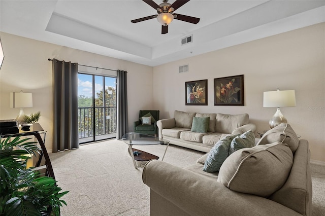 3060 Pirates Retreat Ct Unit 309, Kissimmee, FL 34747 - carpeted living area with a ceiling fan, baseboards, and a raised ceiling