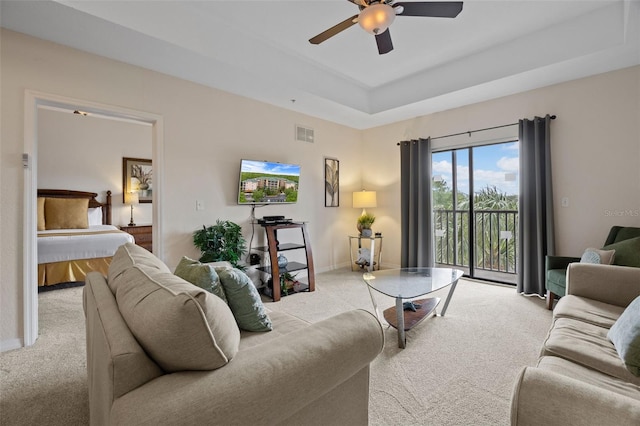 3060 Pirates Retreat Ct Unit 309, Kissimmee, FL 34747 - living room featuring carpet flooring, a ceiling fan, baseboards, and a tray ceiling