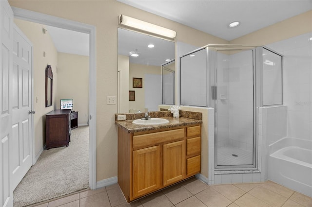 3060 Pirates Retreat Ct Unit 309, Kissimmee, FL 34747 - bathroom featuring tile patterned flooring, a stall shower, vanity, a bath, and recessed lighting