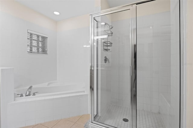 3060 Pirates Retreat Ct Unit 309, Kissimmee, FL 34747 - bathroom featuring a bath, tile patterned flooring, and a shower stall