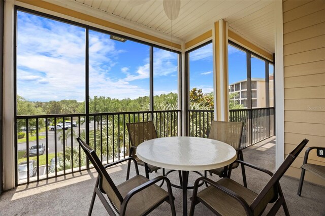3060 Pirates Retreat Ct Unit 309, Kissimmee, FL 34747 - sunroom featuring carpet floors, a ceiling fan, and wooden walls