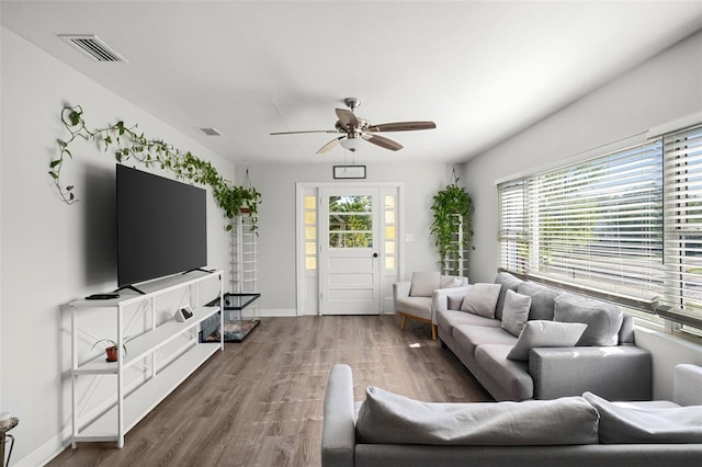 1024 Cohassett Ave, Lake Wales, FL 33853 - living area with wood finished floors, a ceiling fan, and baseboards