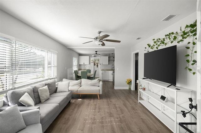 1024 Cohassett Ave, Lake Wales, FL 33853 - living area featuring a ceiling fan, dark wood-style flooring, and baseboards