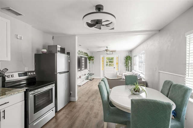 1024 Cohassett Ave, Lake Wales, FL 33853 - dining room with ceiling fan, light wood-style flooring, and baseboards