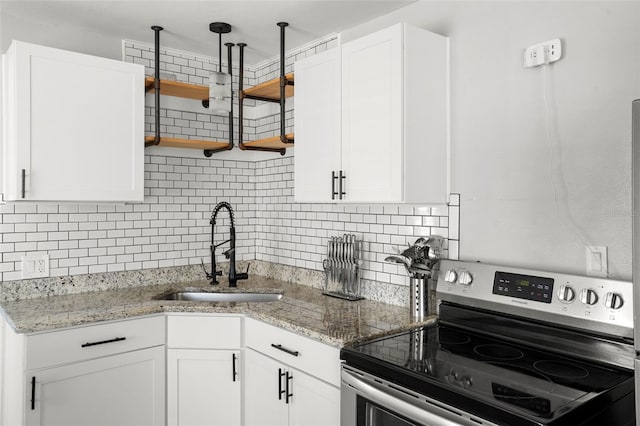 1024 Cohassett Ave, Lake Wales, FL 33853 - kitchen featuring stainless steel electric range oven, a sink, open shelves, white cabinets, and tasteful backsplash
