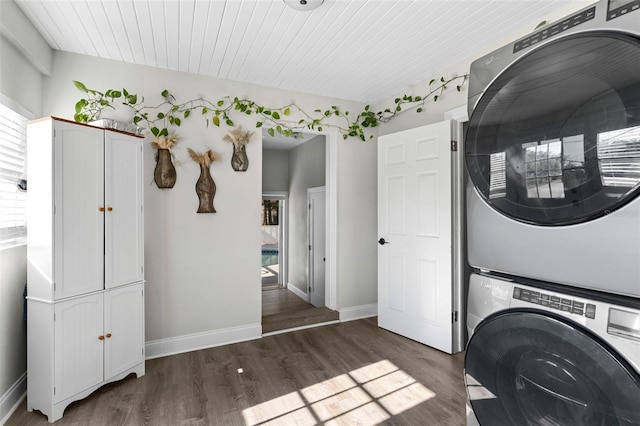 1024 Cohassett Ave, Lake Wales, FL 33853 - laundry room with stacked washing machine and dryer, wood finished floors, baseboards, and cabinet space