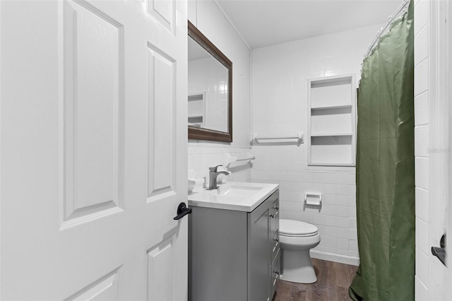1024 Cohassett Ave, Lake Wales, FL 33853 - bathroom with vanity, wood finished floors, tile walls, toilet, and a shower with shower curtain