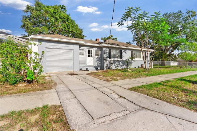 1024 Cohassett Ave, Lake Wales, FL 33853 - single story home with a garage, concrete driveway, and a chimney