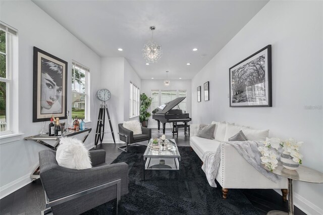 423 Arbor Cir, Celebration, FL 34747 - living area with healthy amount of natural light, wood finished floors, baseboards, a chandelier, and recessed lighting