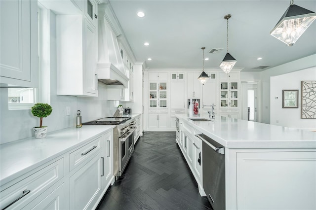 423 Arbor Cir, Celebration, FL 34747 - kitchen featuring stainless steel appliances, premium range hood, a sink, white cabinets, and light countertops