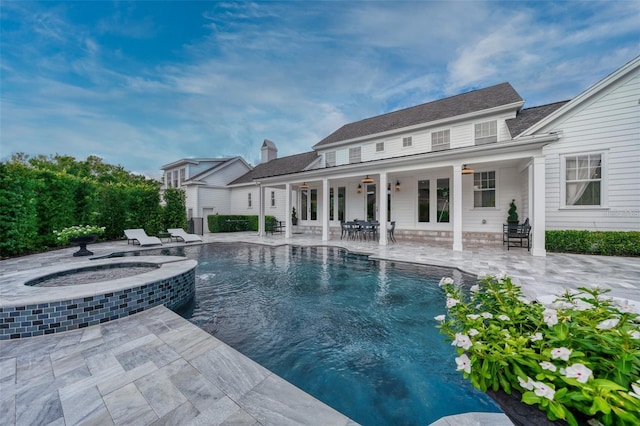 423 Arbor Cir, Celebration, FL 34747 - rear view of property featuring a ceiling fan, a patio, a pool with connected hot tub, and a chimney
