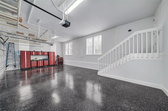 423 Arbor Cir, Celebration, FL 34747 - garage featuring a garage door opener and baseboards