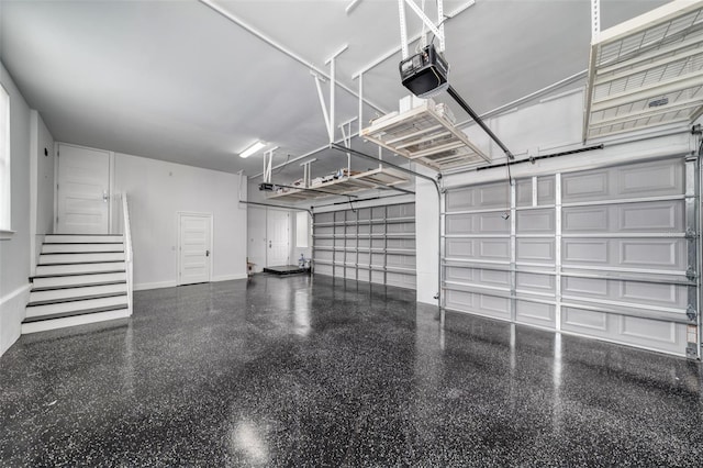 423 Arbor Cir, Celebration, FL 34747 - garage featuring a garage door opener and baseboards