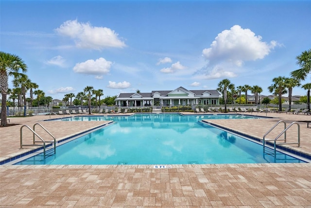 community pool featuring a patio and fence