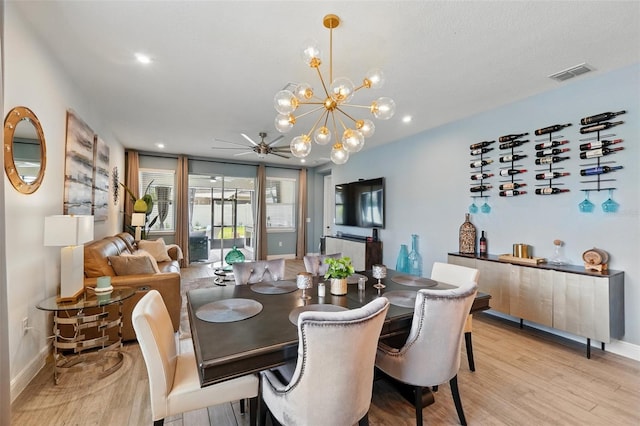 dining room featuring light wood-style floors, baseboards, ceiling fan, a chandelier, and recessed lighting