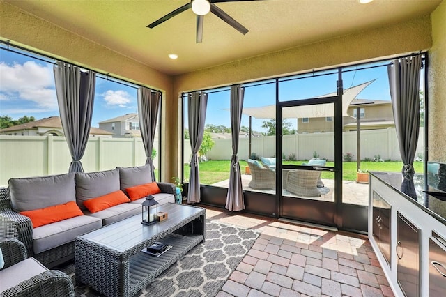 sunroom featuring an outdoor hangout area and a ceiling fan