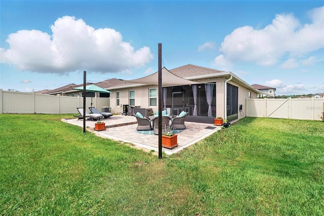 rear view of house featuring a patio, a sunroom, stucco siding, and a shingled roof