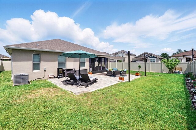 rear view of property with stucco siding, central AC, a patio area, and roof with shingles