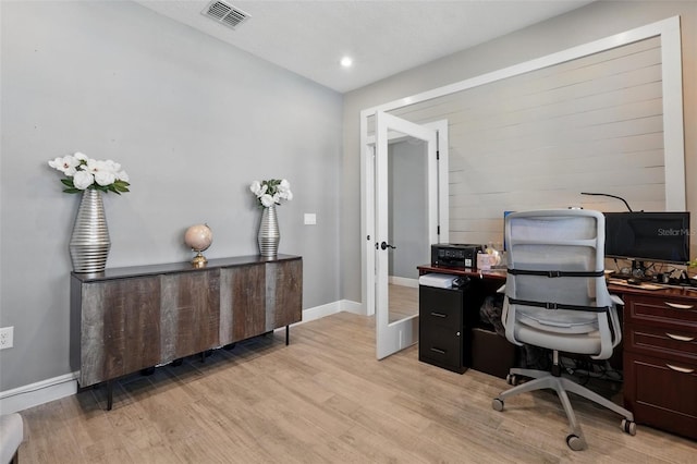 office space with light wood-style flooring and baseboards
