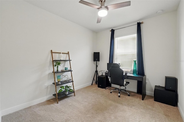 office area featuring carpet, baseboards, and a ceiling fan