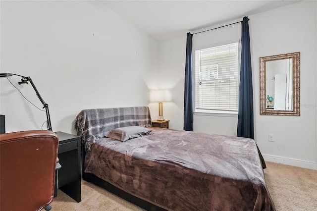 carpeted bedroom featuring baseboards