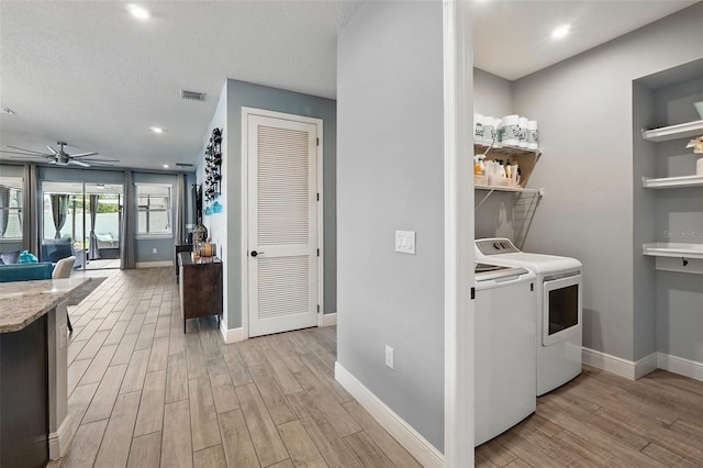 laundry area with separate washer and dryer, light wood-type flooring, a ceiling fan, baseboards, and recessed lighting