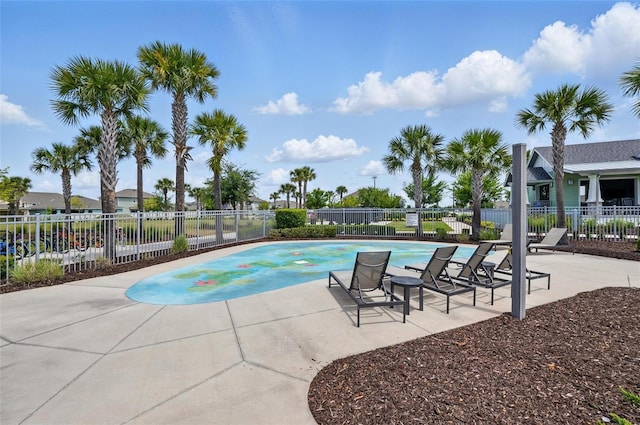 community pool featuring fence and a patio area